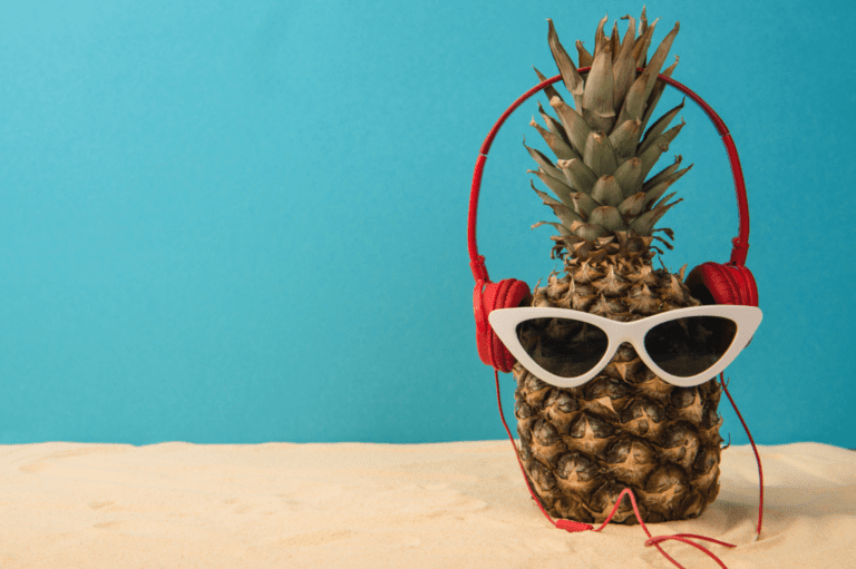 Pineapple with red headphones and white sunglasses