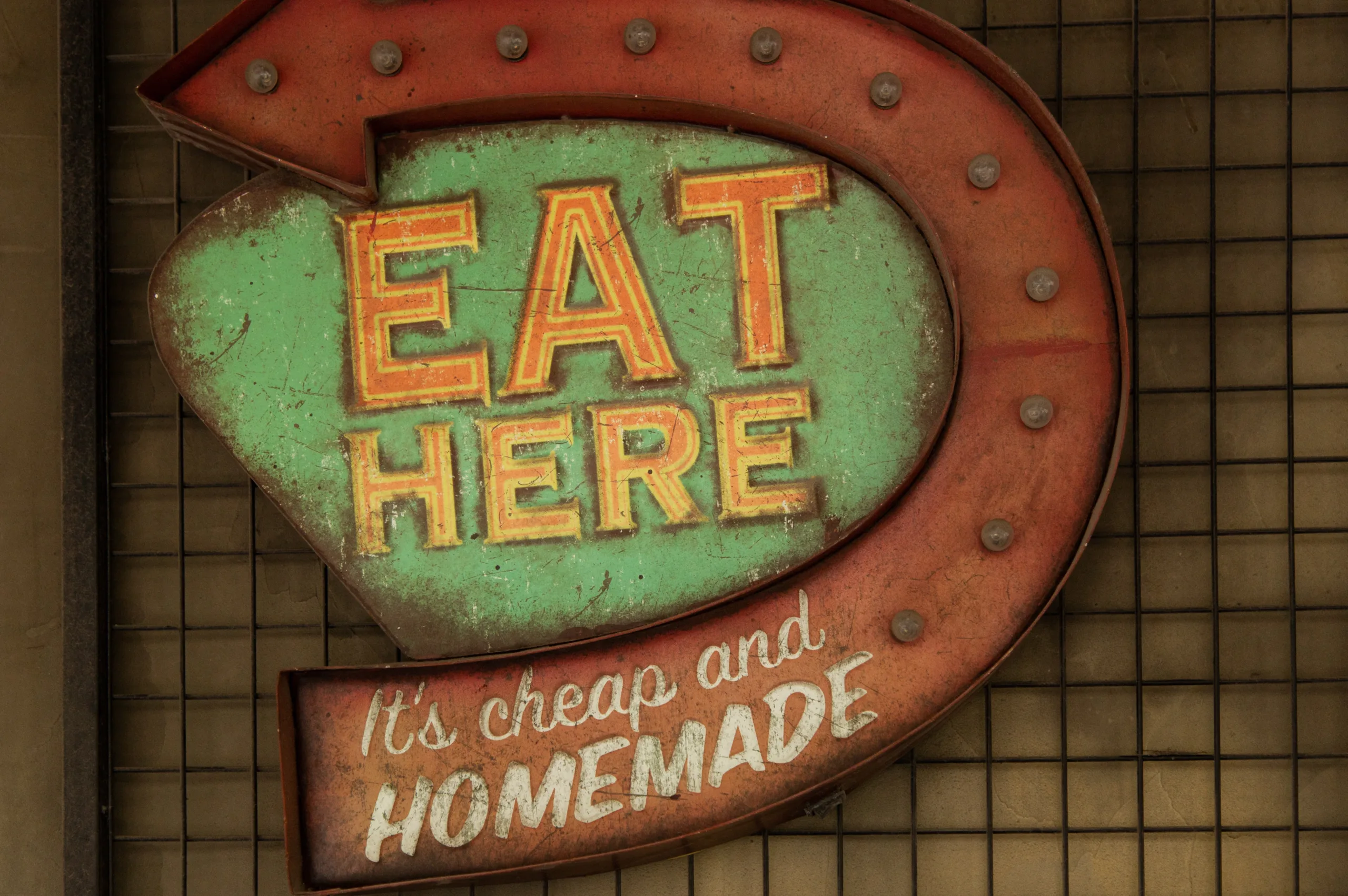 Sign saying "Eat Here: It's Cheap and Homemade"