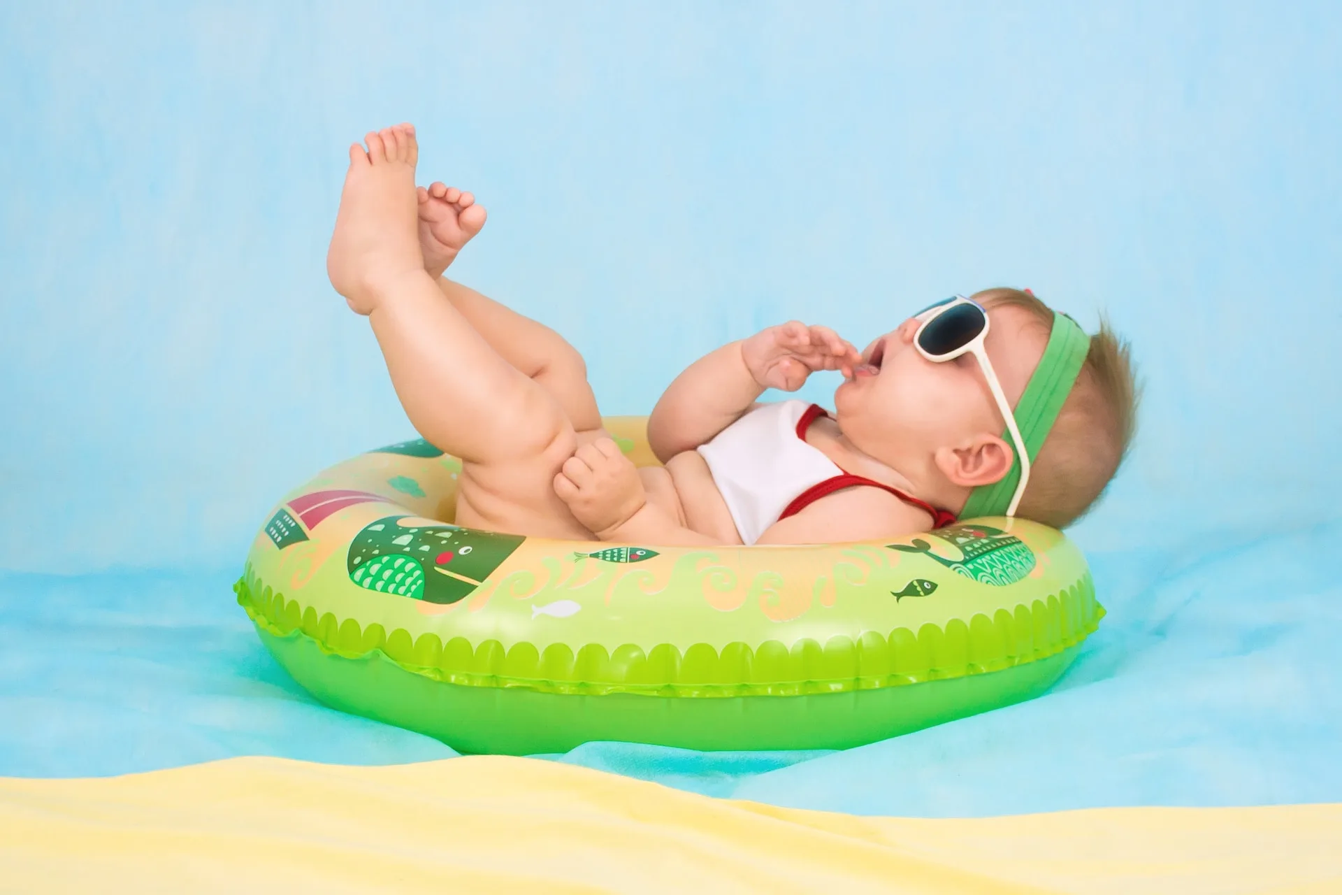 Baby with Sunglasses Floats on Green Pool Float